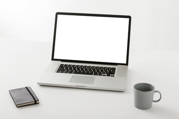 notebook with stationary on the white background.
