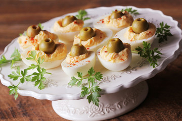 Spicy deviled eggs garnished with green olives