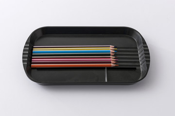 colorful pencil with black tray on the white background.