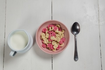 Bowl of honeycomb cereal and milk on wooden table