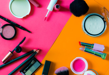 Set of decorative cosmetics blush,powder,mascara and lipstick on color background.