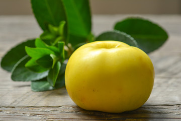 Yellow apple on a wooden surface