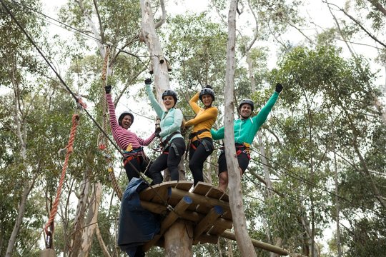 Friends Enjoying Zip Line Adventure In Park