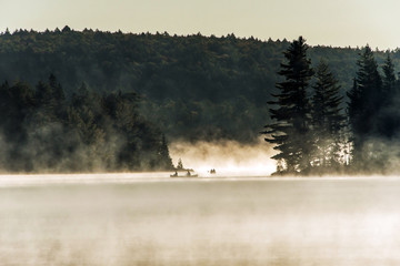 Canada Ontario Lake of two rivers Canoe Canoes foggy water sunrise fog golden hour on water in...