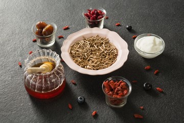 Bowl of cereal bran stick, yogurt, honey and dried fruits