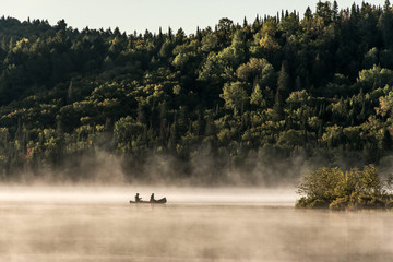 Naklejka na ściany i meble Canada Ontario Lake of two rivers Canoe Canoes foggy water sunrise fog golden hour on water in Algonquin National Park