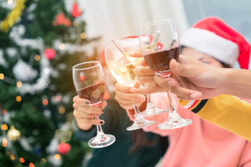 Christmas home party cocktail clink concept, Closeup hands holding glass of wine, champagne friend drinking celebration interior