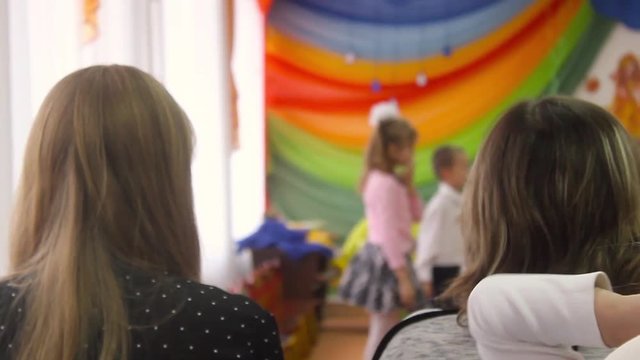 Children sing the song on the stage when parents watch. Theater in kindergarten. Russia