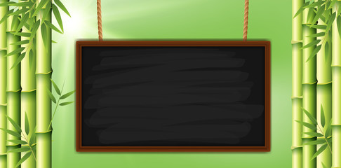 Blank chalkboard with bamboo in background