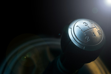 Close up view of a gear lever shift. Manual gearbox. Car interior details. Car transmission. Soft lighting. Abstract view