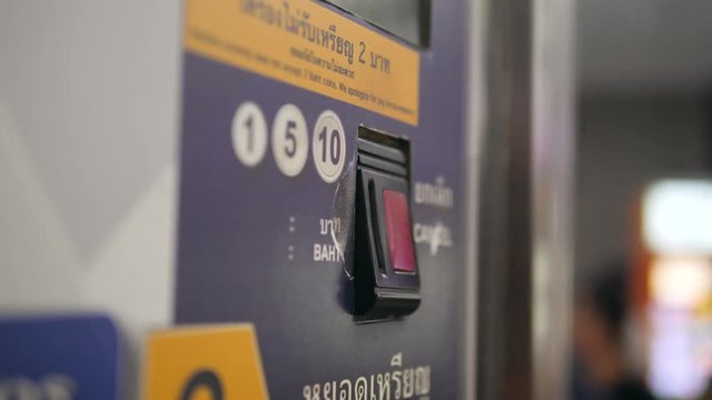 Close Up of Woman's Hand Paying by Coins Subway Ticket in Automatic Vending Machine. 4K.