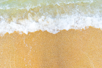 Closed up foamy wave on beach.