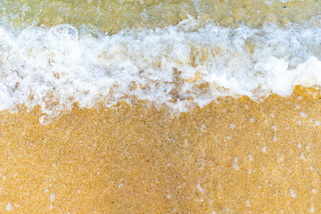 Closed up foamy wave on beach.