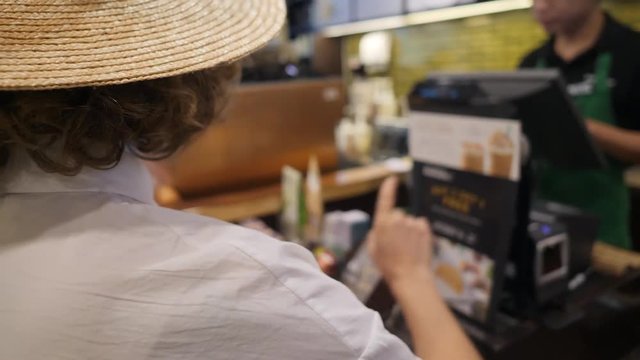 Young Tourist Woman Customer at Coffee Shop Counter Making Order. 4K.