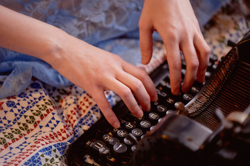 A creative person, author of books, writer of bestsellers, a journalist typing on an old typewriter. Inspiration in the work