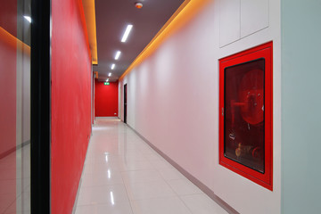 Emergency exit of the building with fire exit sign,fire alarm and Fire extinguisher