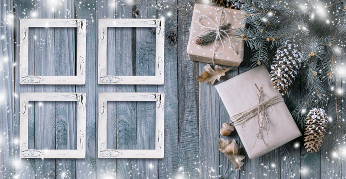 Christmas background with gift box and frames on wooden planks