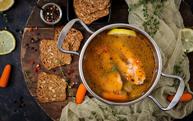 Salmon fish soup with vegetables in pan. Flat lay. Top view