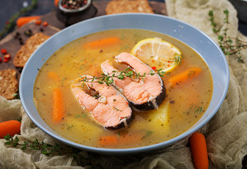 Salmon fish soup with vegetables in bowl.