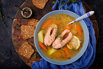 Salmon fish soup with vegetables in bowl. Flat lay. Top view