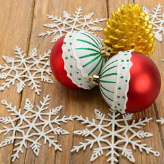 Christmas decorations and candle in on a wooden surface