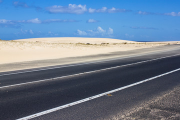 Coast asphalt road. Sunrise on asphalt coat, macro photo of road. Beach way. Highway in Spain.