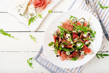 Prosciutto di Parma salad with figs and blue cheese. Flat lay. Top view