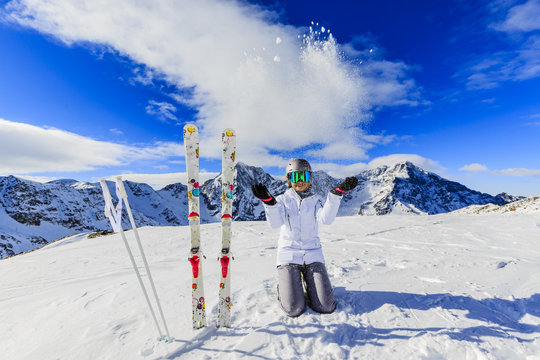 Girl on skiing on snow on a sunny day in the mountains. Ski in winter seasonon, the tops of snowy mountains in sunny day. South Tirol, Solda in Italy.