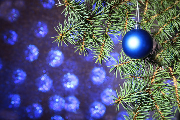 Decorated with colorful balls Christmas tree on a blurry, sparkling and fabulous background.