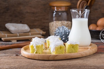 Coconut cake on wooden plate.