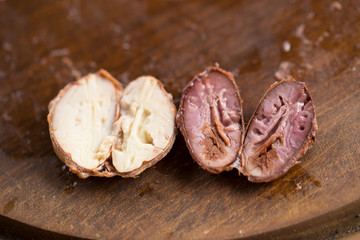 Choosing raw cacao beans with hand of man