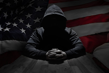 Concept hacker at work with usa flag on background