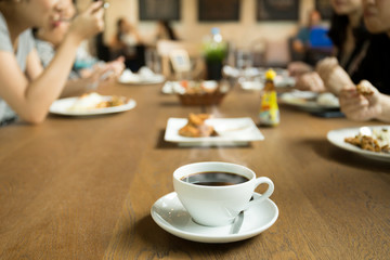 Selected focus cup of coffee with family dinner time