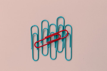 Colored paper red clip with a difference on blue clips other. minimal concept. Ideas about showing leadership in various ways. education, better business