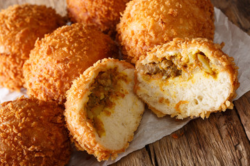 Snack Japanese bread curry kare-pan macro on paper. horizontal