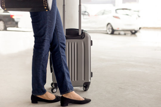 Woman tourist standing with luggage waiting for taxi