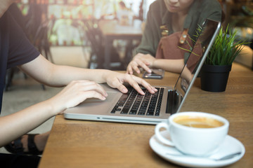 Young business people team up working with computer