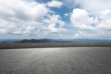 empty asphalt road with green hill in cloud sky