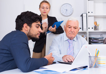 Mature man is talking to colleague