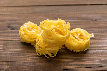 Fettuccine on a wooden background.