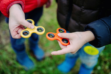 Two fidget spinners. Outdoor.