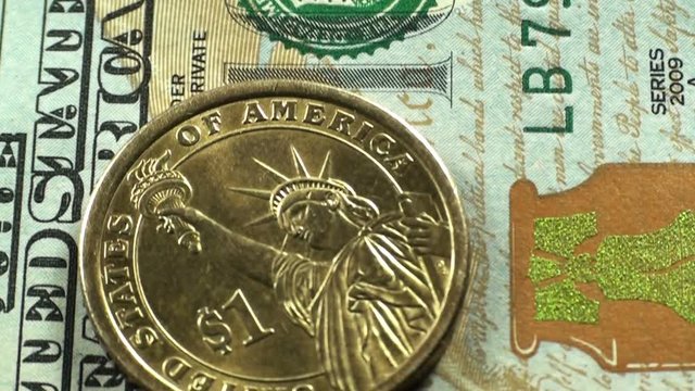 Macro view of a hundred dollar bills and coin of one dollar. Camera movement on a banknote. HD 1920x1080 Video Clip