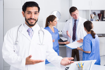 Fototapeta premium Bearded doctor inviting in medical office