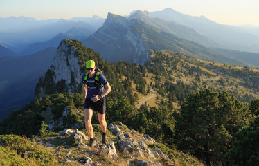 Fototapeta na wymiar Man trailrunning in the mountains on a beautiful afternoon. Vercors, France.