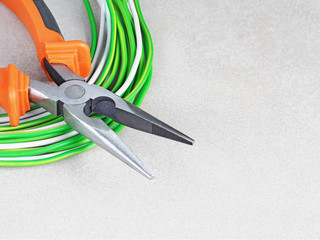  Tools for electrician and cables on grey surface