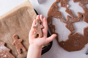 Hands of little boy sheeting dough . Christmas baking preparation. Child's hands with a rolling pin baking Christmas gingerbread cookies. Christmas cookies concept. Top view.