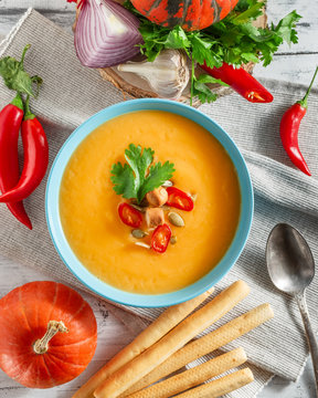 Spicy pumpkin soup with chili pepper in bowl