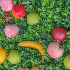 Mix of colorful fruit on green grass, background