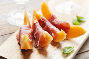 Slices of cantaloupe melon and prosciutto ham, shallow DOF