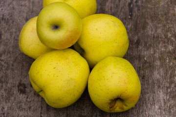 Ripe green apples on rustic wooden table